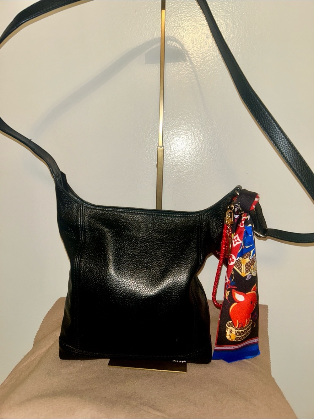 The Sak De Young Crossbody in black pebbled leather. Fashion Bag Charm included.
